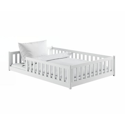 White crib with a white mattress on a white background