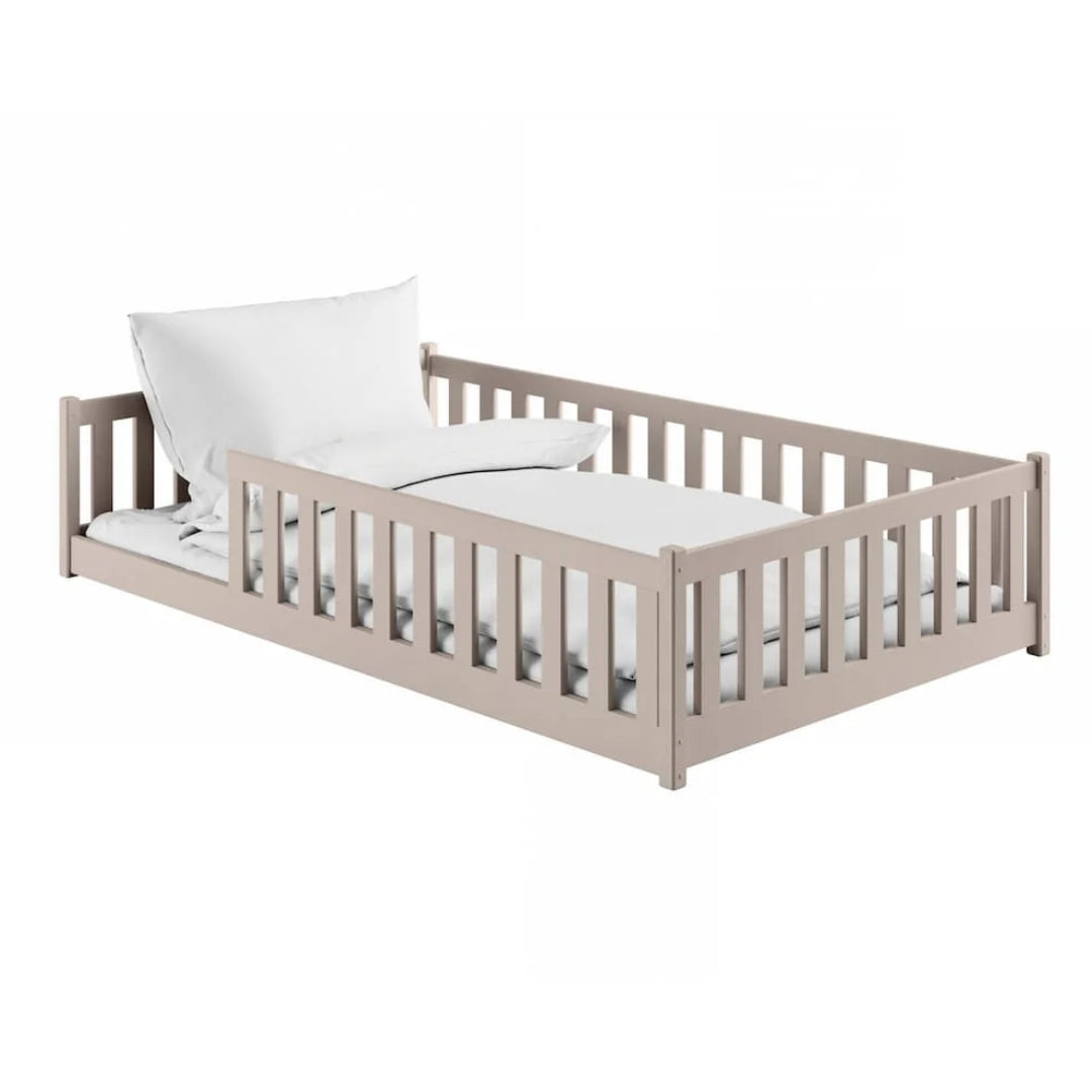 Children's bed with white mattress and pillow on a white background