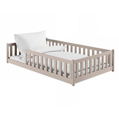 Children's bed with white mattress and pillow on a white background