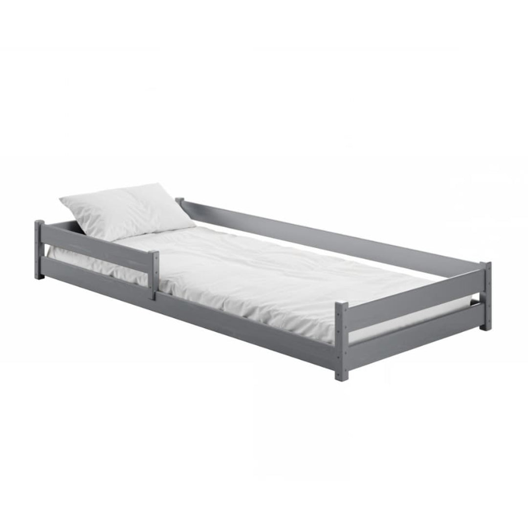 Gray bed frame with white mattress and pillow on a white background