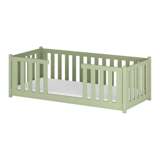 Green crib with white mattress on a white background