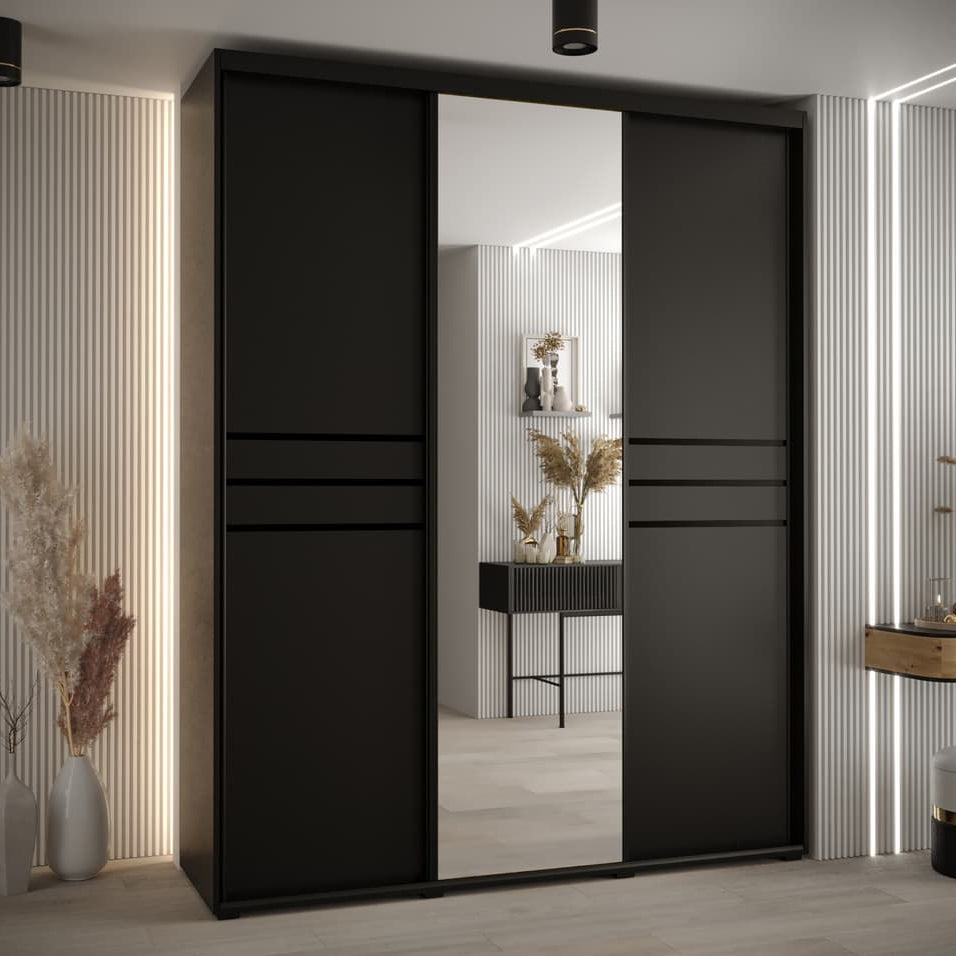 Black sliding wardrobe door with mirror in a modern room setting.