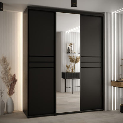 Black sliding wardrobe door with mirror in a modern room setting.