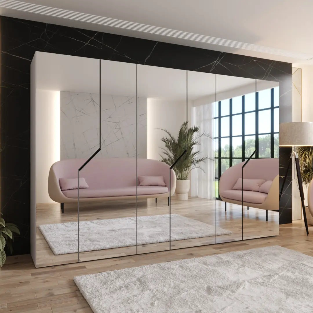 Modern interior design with a pink sofa and large mirror reflecting the room.