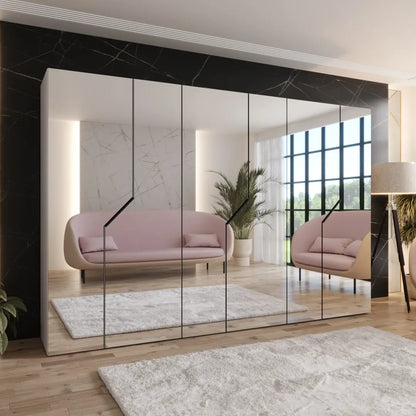 Modern interior design with a pink sofa and large mirror reflecting the room.