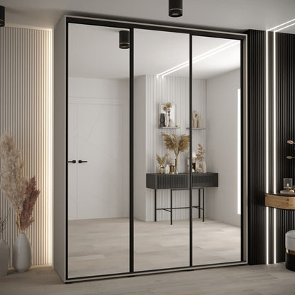 Modern sliding wardrobe with glass doors in a stylish room.