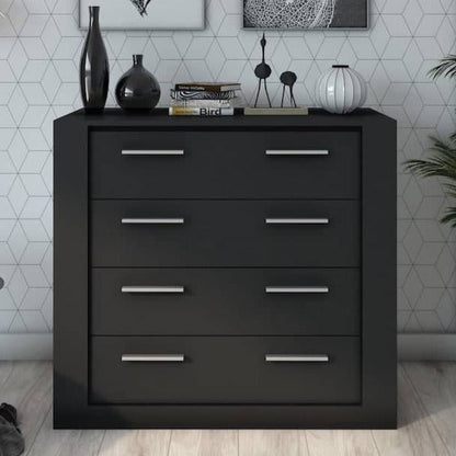 Black dresser with four drawers against a geometric-patterned wall.