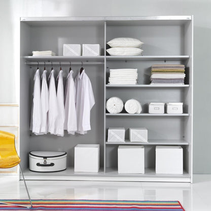 Modern wardrobe with clothes and shelves in a minimalistic room.